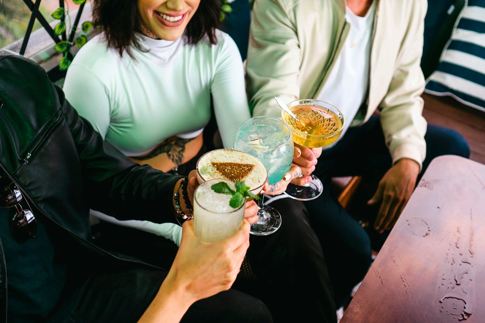A group raising their glasses together around a table.