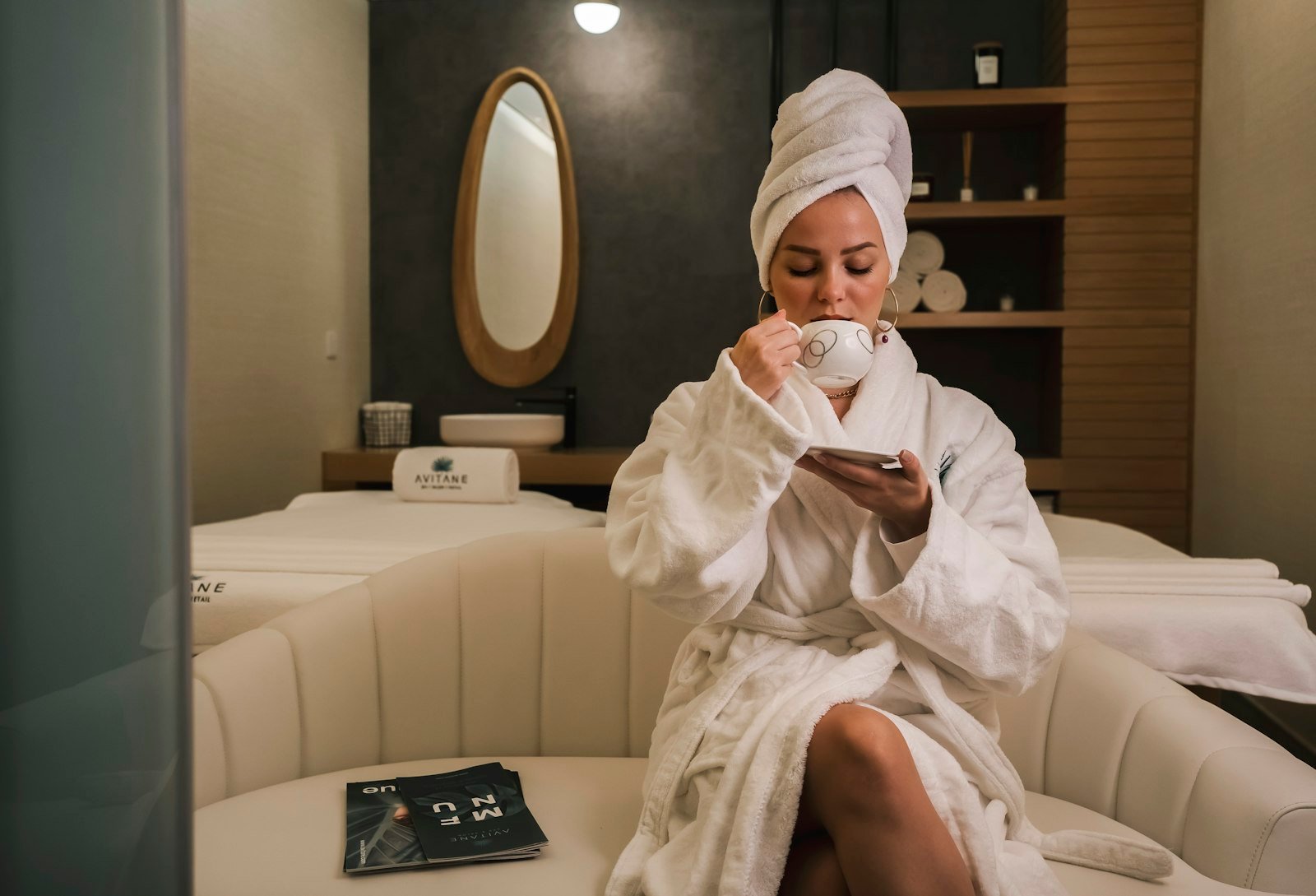 A woman in a white robe relaxing after a spa treatment.